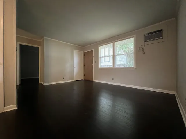 a view of a livingroom with wooden floor and a window