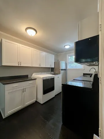 a kitchen with a sink and white cabinets