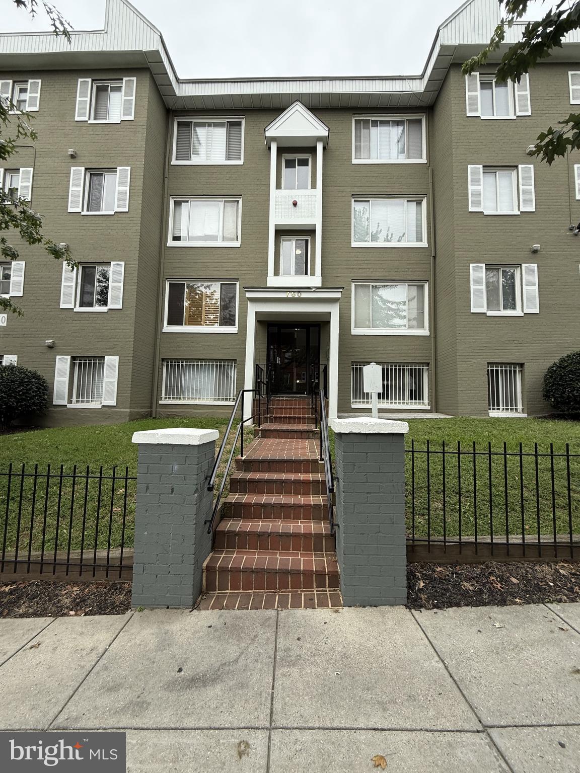 a view of a brick building and many windows