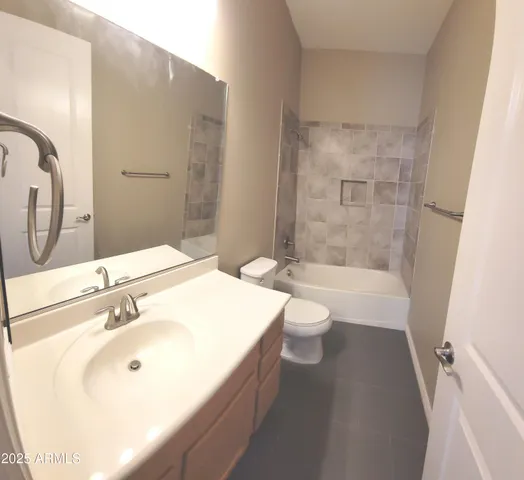 a bathroom with a granite countertop shower and a sink