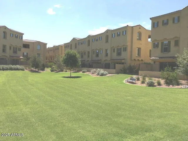a view of a patio with table and chairs under an umbrella