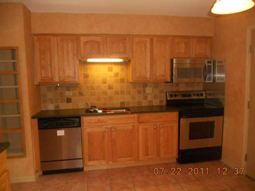 351 North Rohlwing Road Palatine, IL 60074 - Photo 6 of 11 a kitchen with stainless steel appliances granite countertop a stove and a refrigerator