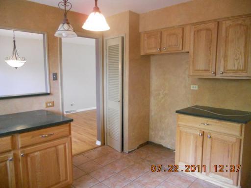 351 North Rohlwing Road Palatine, IL 60074 - Photo 7 of 11 a kitchen with stainless steel appliances granite countertop white cabinets and a granite counter tops