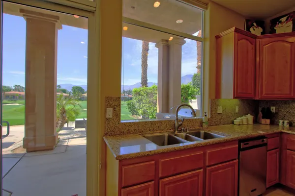 a kitchen that has a sink and a large window