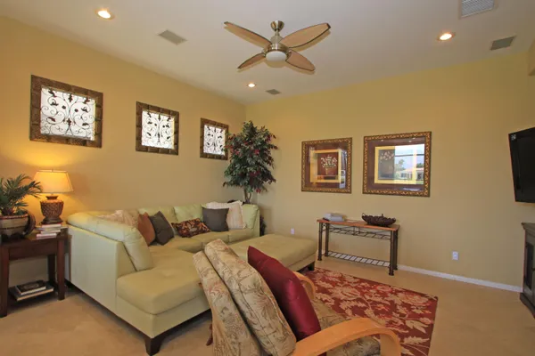 a living room with furniture and a potted plant