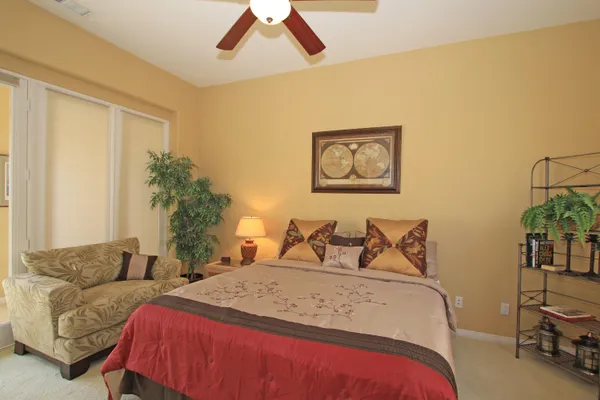 a bedroom with a bed and a potted plant