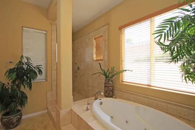 a view of hallway with window and wooden floor
