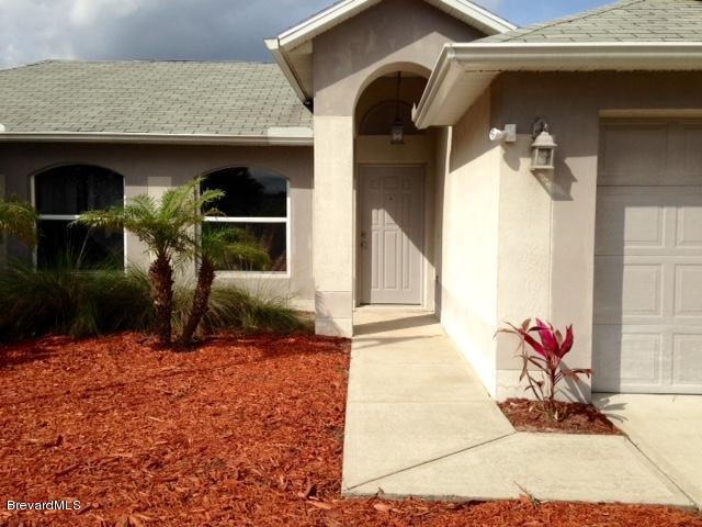 2882 Digby Road Southeast Palm Bay, FL 32909 - Photo 2 of 34 Entrance with Coach Lights beside Garage