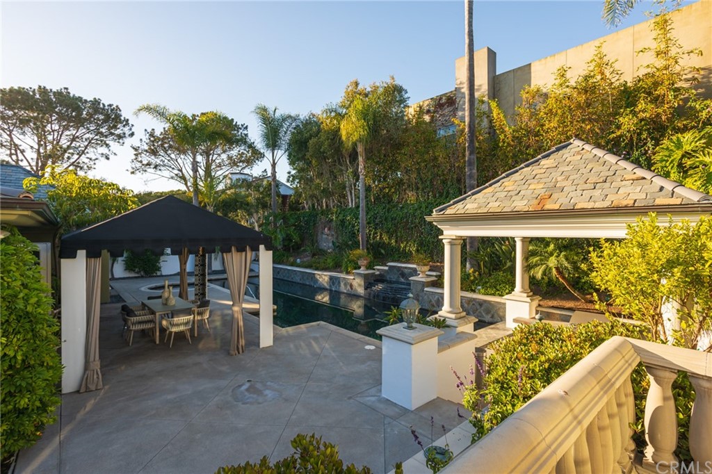 40 Smithcliffs Road Laguna Beach, CA 92651 - Photo 33 of 50 a patio with tables and chairs under an umbrella