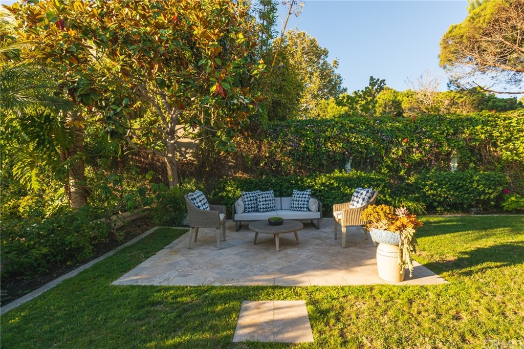 40 Smithcliffs Road Laguna Beach, CA 92651 - Photo 34 of 50 a view of a patio with table and chairs potted plants and large tree