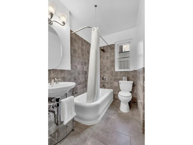 a view of a dining room with furniture and a window