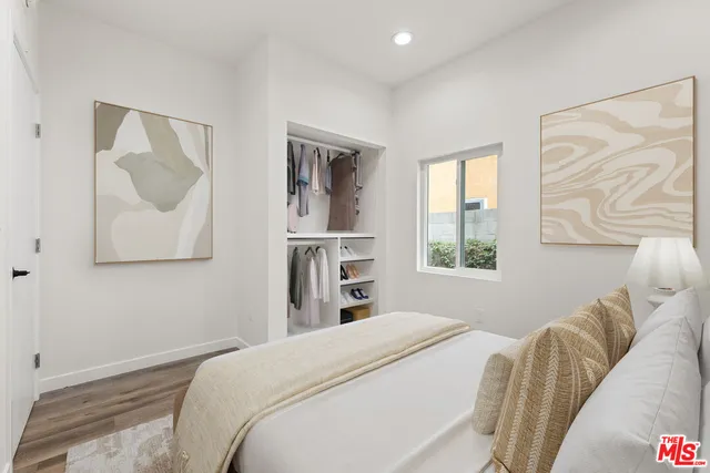 a bedroom with a bed and a painting on the wall