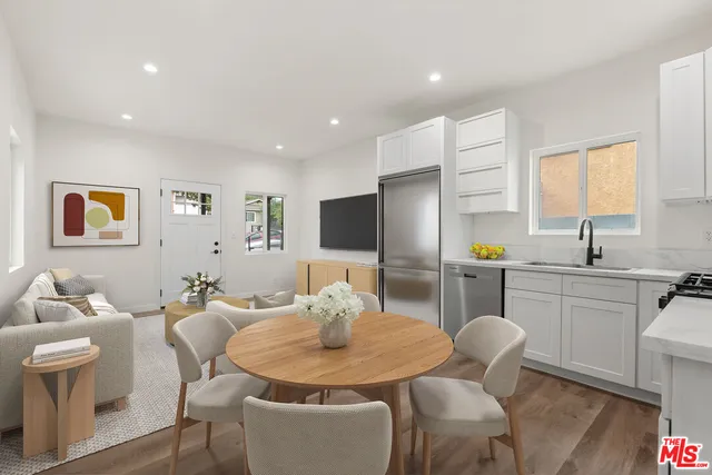 a large kitchen with a table and chairs