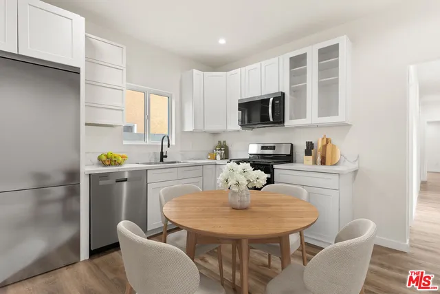 a kitchen with a sink cabinets and appliances