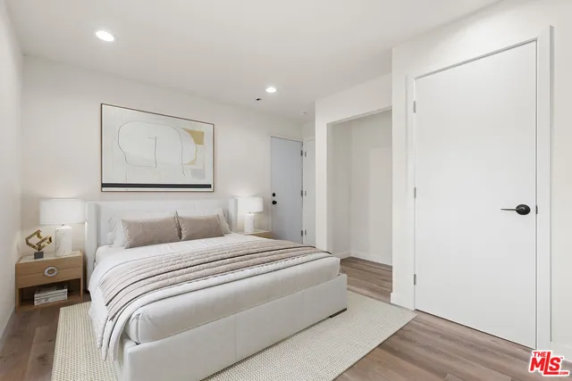 a bedroom with a bed and a painting on the wall