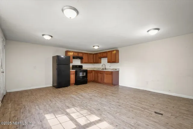 a kitchen with stainless steel appliances a refrigerator and a sink