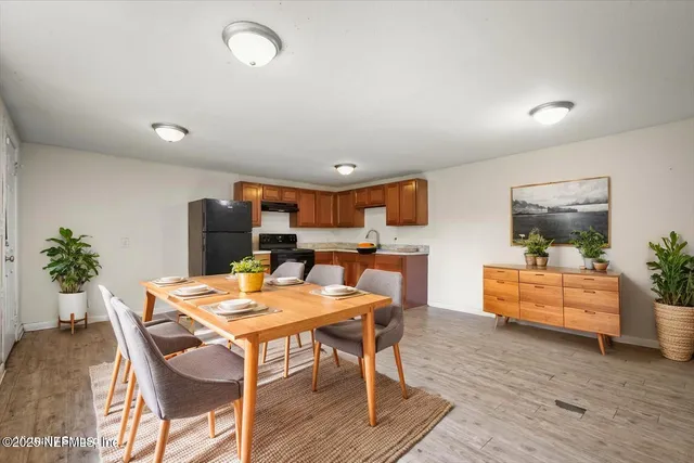 a view of a dining room with furniture window and wooden floor