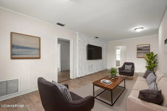 a living room with furniture and a flat screen tv