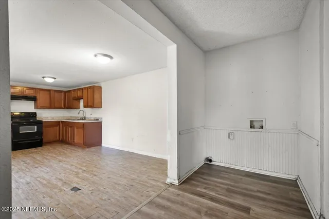 a view of kitchen with a sink and cabinets