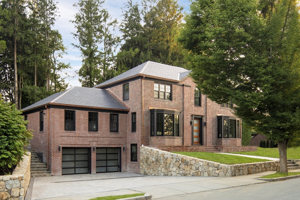 a front view of a house with a garden