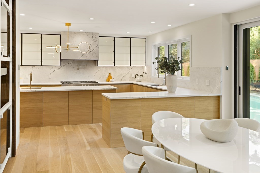 115 Mandalay Road Newton, MA 02459 - Photo 9 of 27 a kitchen with stainless steel appliances granite countertop a sink and a white cabinets