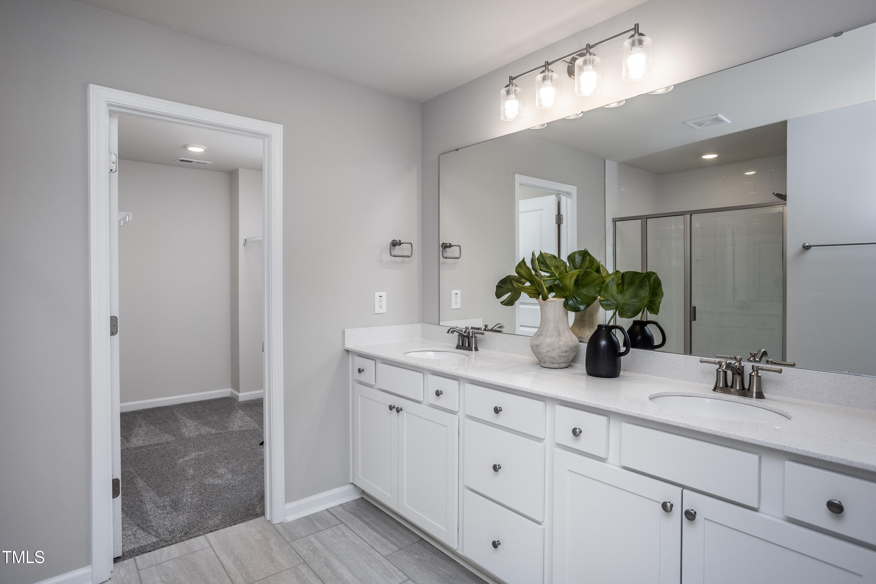 281 Brookside Drive Raleigh, NC 27603 - Photo 11 of 24 a bathroom with a granite countertop sink a mirror and a potted plant