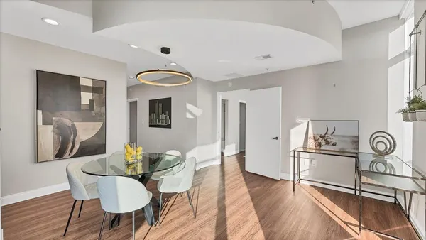 a dining room with furniture and wooden floor