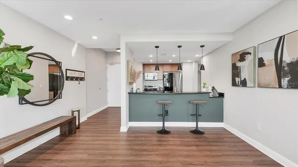 a living room with furniture and a wooden floor