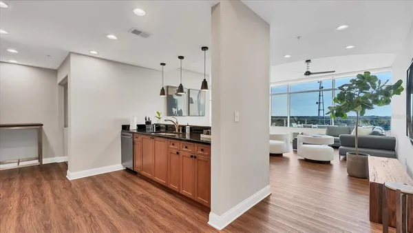 a view of living room with furniture and wooden floor