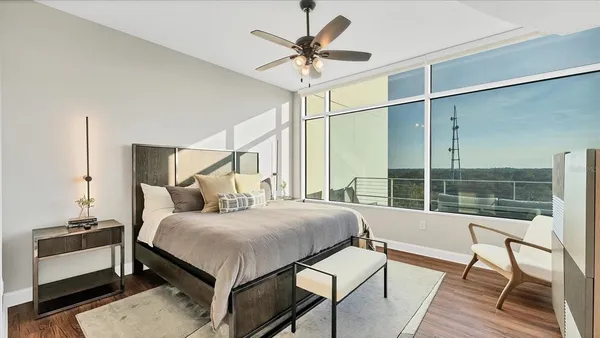 a bedroom with a bed and a chandelier