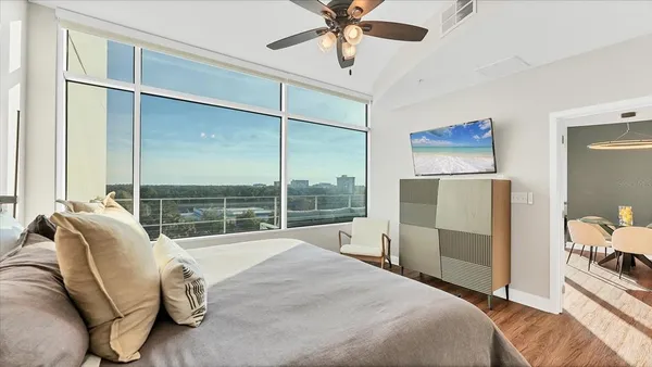 a bedroom with a bed and a large window