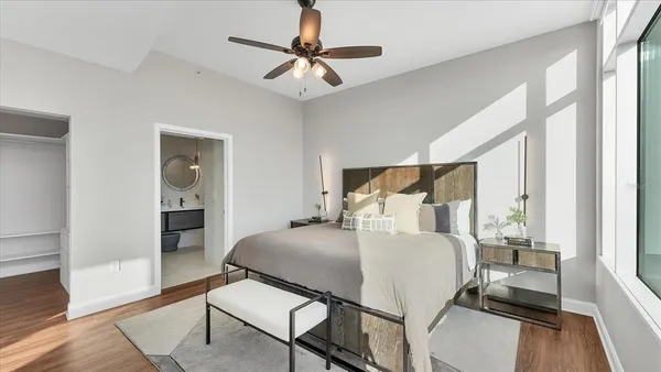 a bedroom with a bed and wooden floor