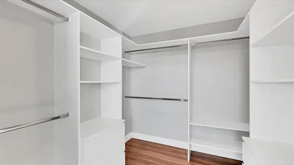 a view of walk in closet with empty racks