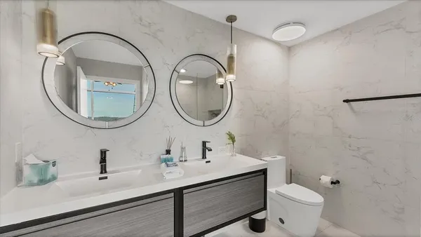 a bathroom with a toilet a sink and a mirror