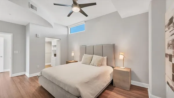 a bedroom with a bed and wooden floor