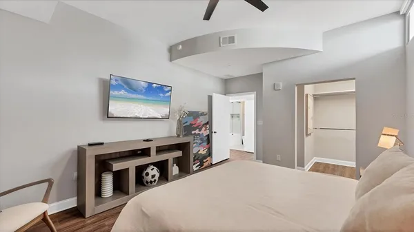a bedroom with a bed and a flat screen tv