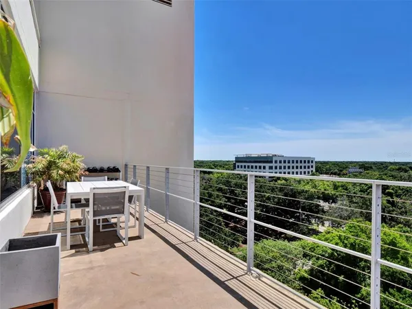 a view of a chairs and table in the balcony