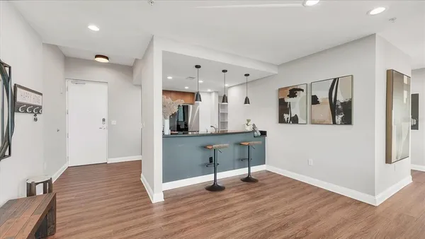 a view of a room with wooden floor and furniture