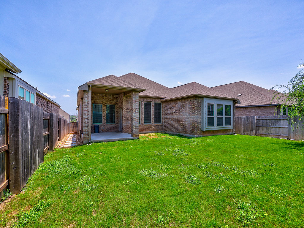 229 Heartleaf Road San Marcos, TX 78666 - Photo 4 of 40 A well-maintained lawn and brick exterior provide classic curb appeal.