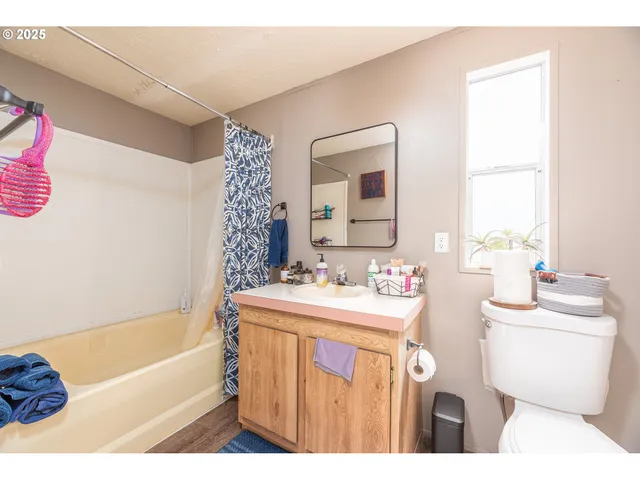 a bathroom with a sink a toilet a tub and shower