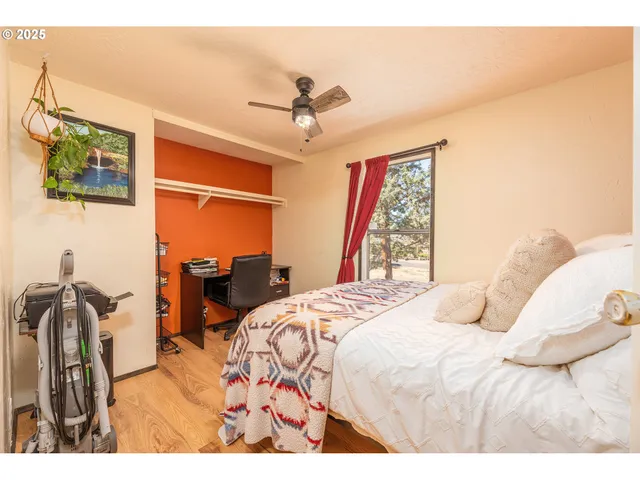 a bedroom with a bed dresser and a window