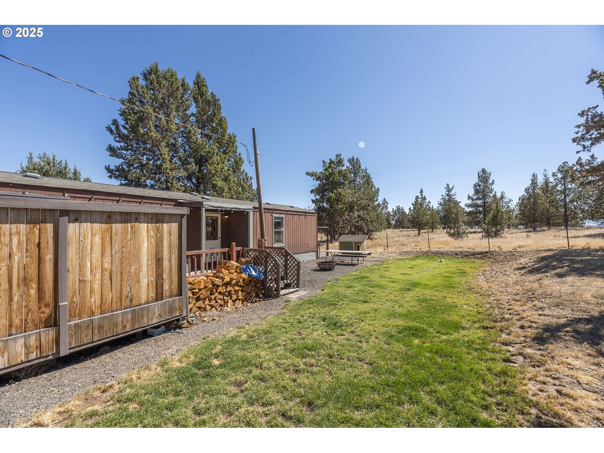 13406 Southwest Oasis Court Terrebonne, OR 97760 - Photo 23 of 48 a backyard of a house with table and chairs