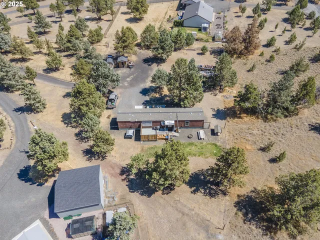 an aerial view of a house with a yard and lake view