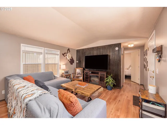 a bedroom with a bed and a flat screen television