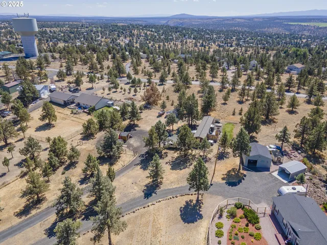 an aerial view of residential house and sandy dunes