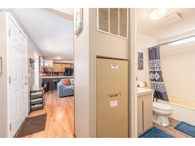 a bathroom with a toilet a sink and a large mirror