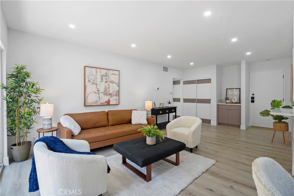1730 Camino Palmero Street, Unit 316 Los Angeles, CA 90046 - Photo 12 of 27 a living room with furniture and a potted plant