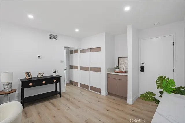 a kitchen with stainless steel appliances kitchen island granite countertop a refrigerator and a stove top oven