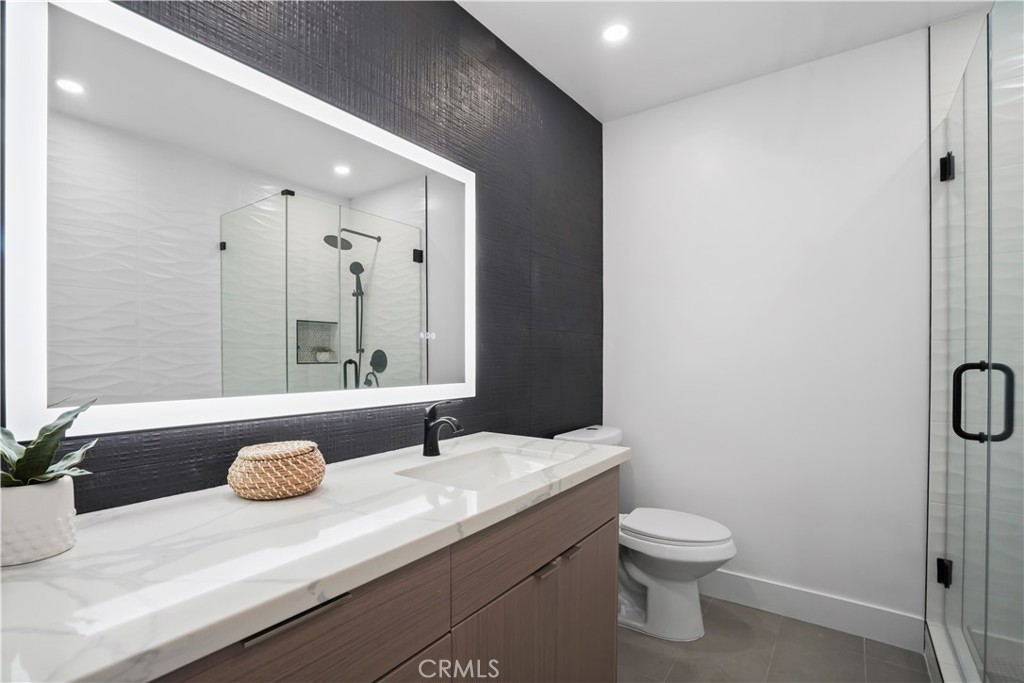1730 Camino Palmero Street, Unit 316 Los Angeles, CA 90046 - Photo 15 of 27 a bathroom with a sink toilet and shower
