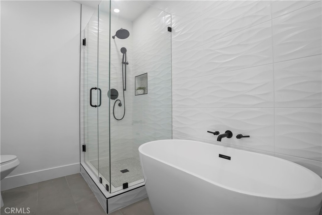 1730 Camino Palmero Street, Unit 316 Los Angeles, CA 90046 - Photo 16 of 27 a bathroom with a bathtub a toilet and a shower